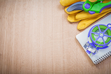 Gardening safety gloves secateurs soft wire tie copybook on wood