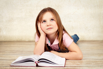 Beautiful little girl reading book