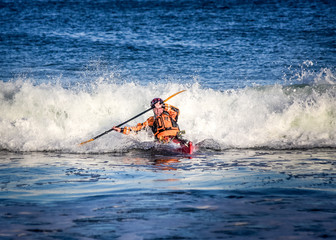 Kayak surfer in action