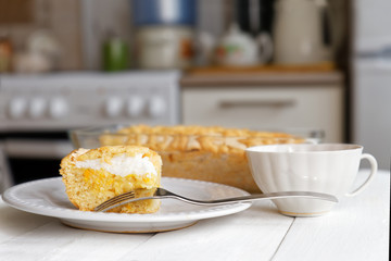 Piece of cake with lemon-orange filling and meringue