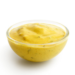 Small glass condiment bowl of  yellow curry sauce. Isolated.