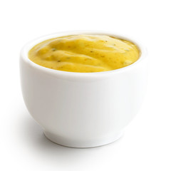 Small condiment bowl of  yellow curry sauce. Isolated.