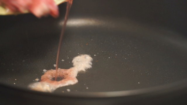 girl fry finely chopped meat in a frying pan