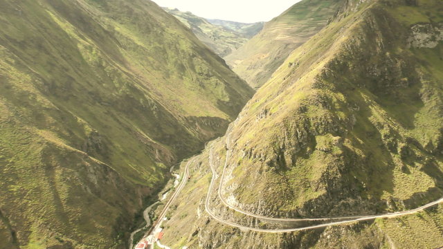 Capture breathtaking aerial views of the iconic Nariz del Diablo train route in Ecuador with a mesmerizing camera panning from a high altitude.