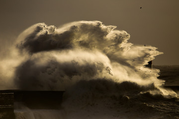 Storm with big waves near a lighthouse