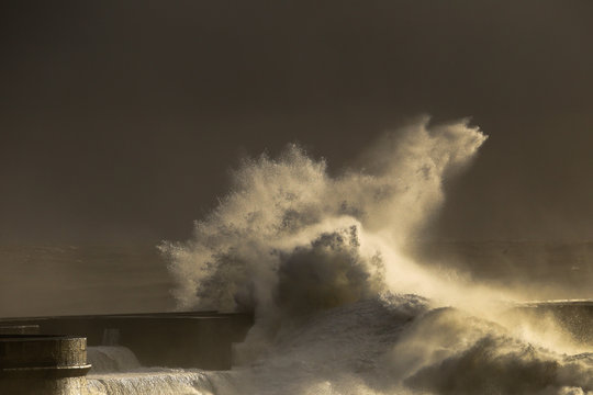 Storm with big waves near a lighthouse