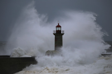 Fototapeta na wymiar Storm with big waves near a lighthouse
