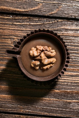 walnut in a chocolate basket on a wooden table