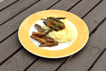 Fried small fish with mashed potatoes