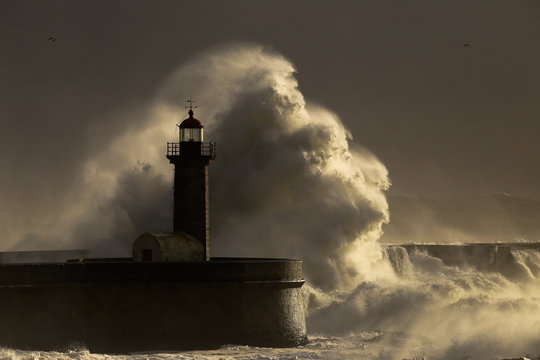 Storm with big waves near a lighthouse