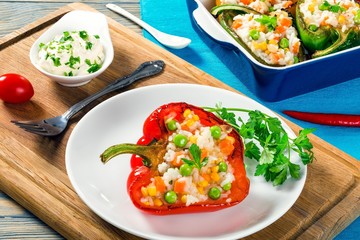 bell pepper stuffed with rice, green peas, carrots, close-up