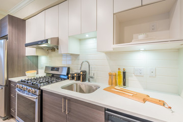 Fototapeta na wymiar Modern, bright, clean, kitchen interior with stainless steel appliances in a luxury house