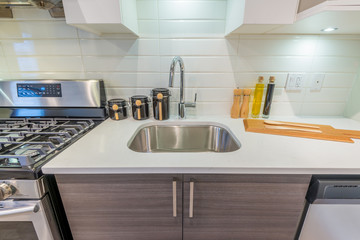 Fototapeta na wymiar Modern, bright, clean, kitchen interior with stainless steel appliances in a luxury house