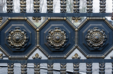Golden and black vintage forged metal fence at medieval style