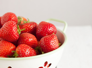 Close up of Fresh strawberries in a colander.