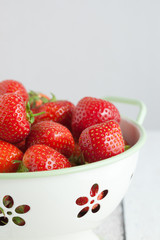 Close up of Fresh strawberries in a colander.