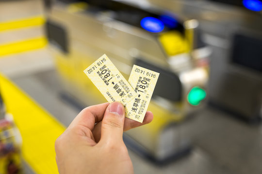 man holding japan train ticket in TOKYO station