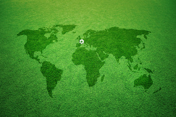 Soccer field with world map Europe caption and small soccer ball.