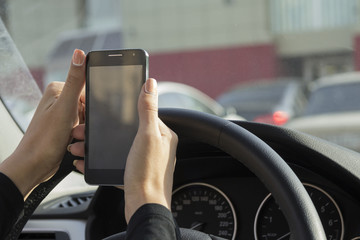 the girl picks up a text message on a mobile phone in the car