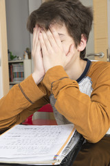 Obraz premium Teenage boy studying with digital tablet at home
