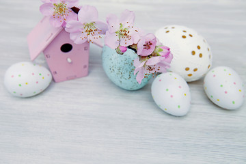 Easter eggs with branch of cherry tree flowers