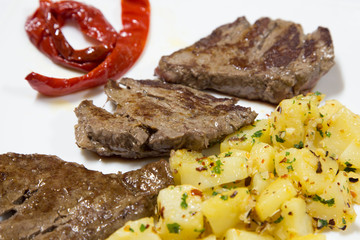 Fillet of beef with potatoes isolated on white. close up shot