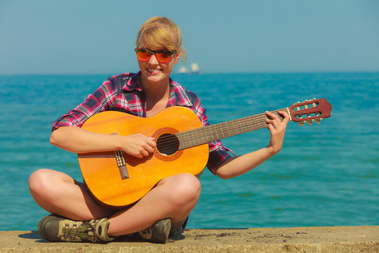 Young woman with guitar outdoor