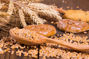 Assortment of baked bread on wooden table background