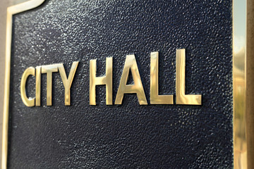 City Hall sign on the front of a local government building photo