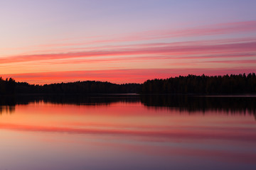 Serene view of calm lake and tree silhouettes