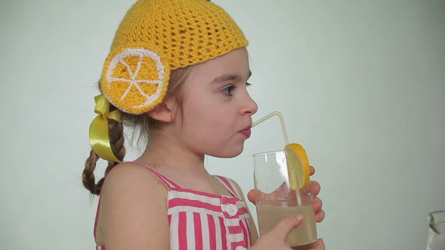 Girl drinking lemonade through a straw