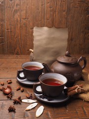 old paper and tea set on a wooden background