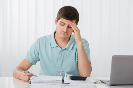 Unhappy Man Calculating Tax