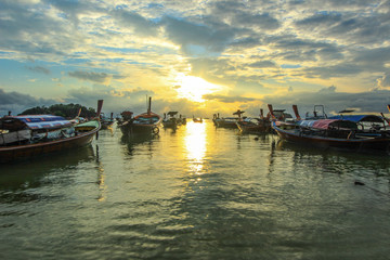 Boats on shore with sunset background