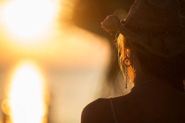 young woman staying back of the head in summer light
