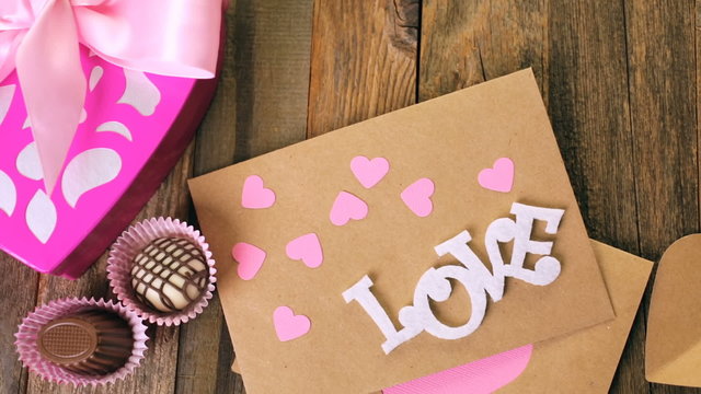 Chocolates in heart shaped box on rustic wood table