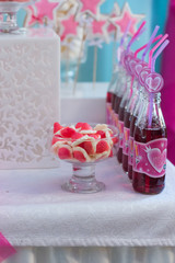 Candy jar and fancy  bottles for drinks on a dessert table at party