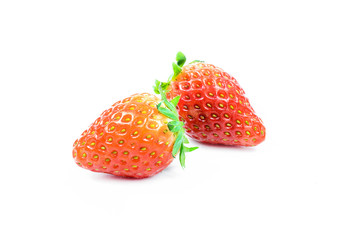 Two strawberries close up on white background
