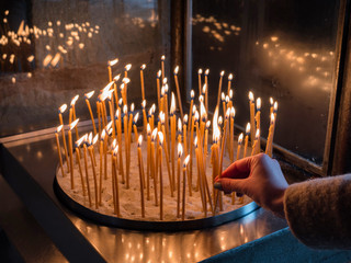 hand holding a candle in a Monastery