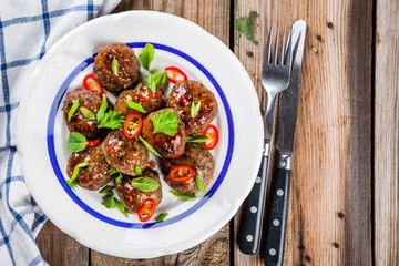 homemade meatballs with mint, green onions and chili sauce