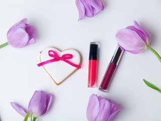 tulip, cookie and lipsticks on the white background