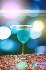 Blue Cocktail. Blurred Bokeh Lights.