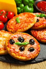 Mix of mini pizzas on a stone try