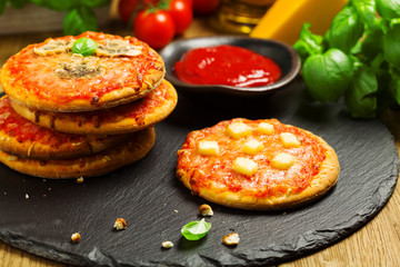 Mix of mini pizzas on a stone try