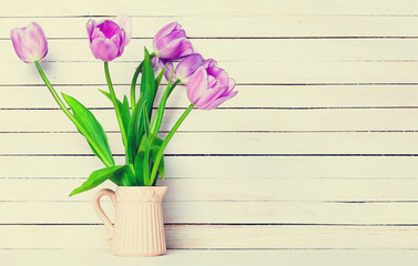 bunch of tulips on the wooden background