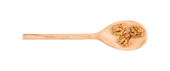 Walnuts on a wooden spoon isolated white background