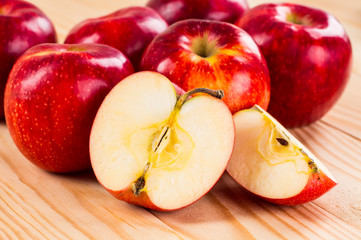 Ripe red apples on wooden background
