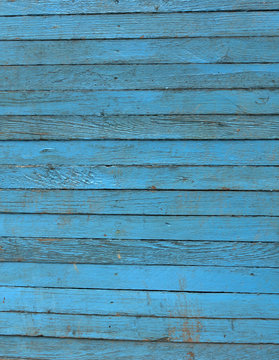 weathered blue wooden hangar wall.