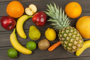 Obraz na płótnie Canvas Healthy fruit for diet. Fresh fruit on dark wooden board. A healthy diet with vitamins. 