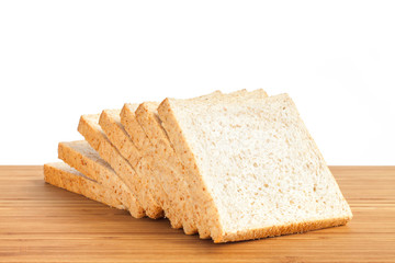 Bread, whole wheat slice on wooden table isolated in white backg